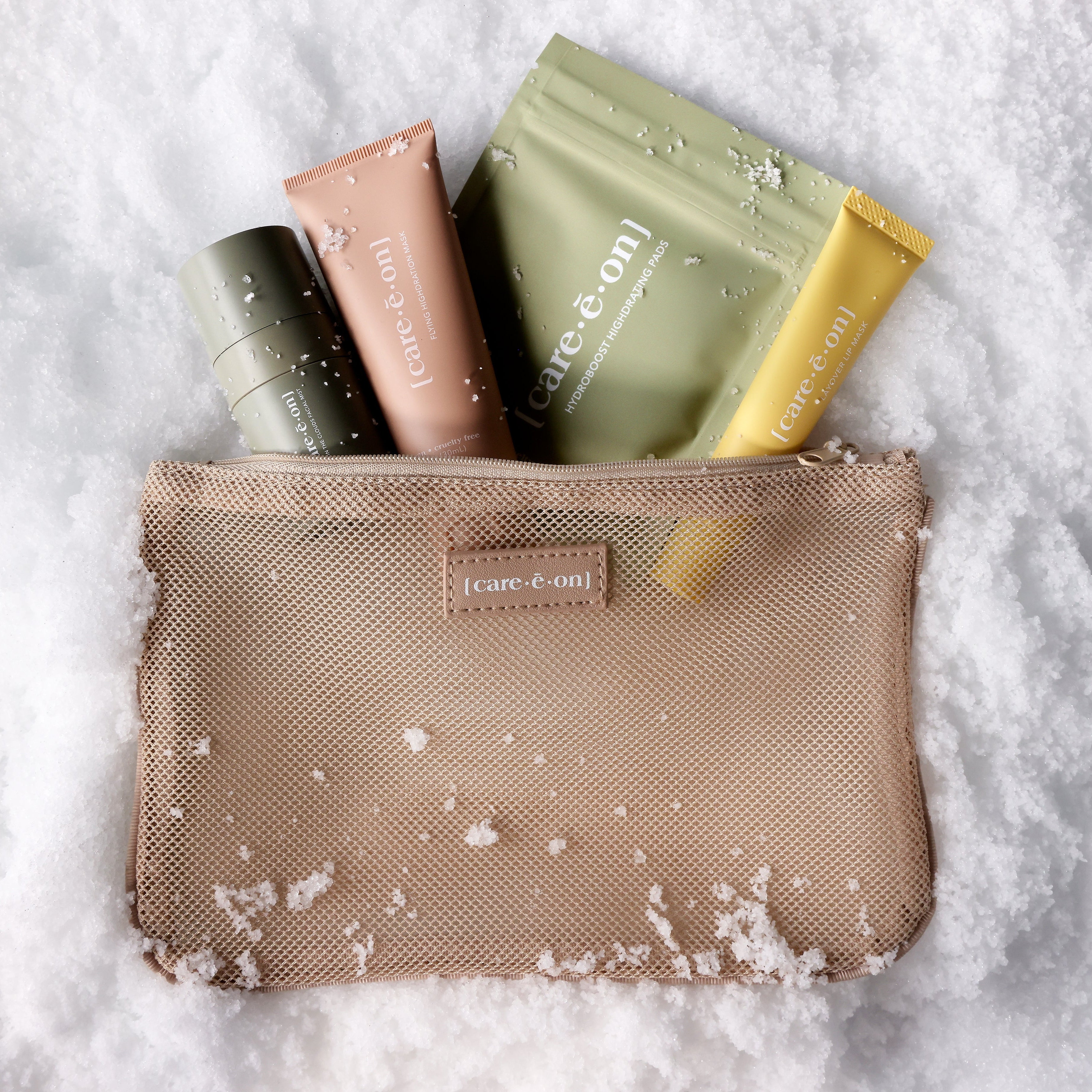 Cosmetic bag with skincare products on a snowy background
