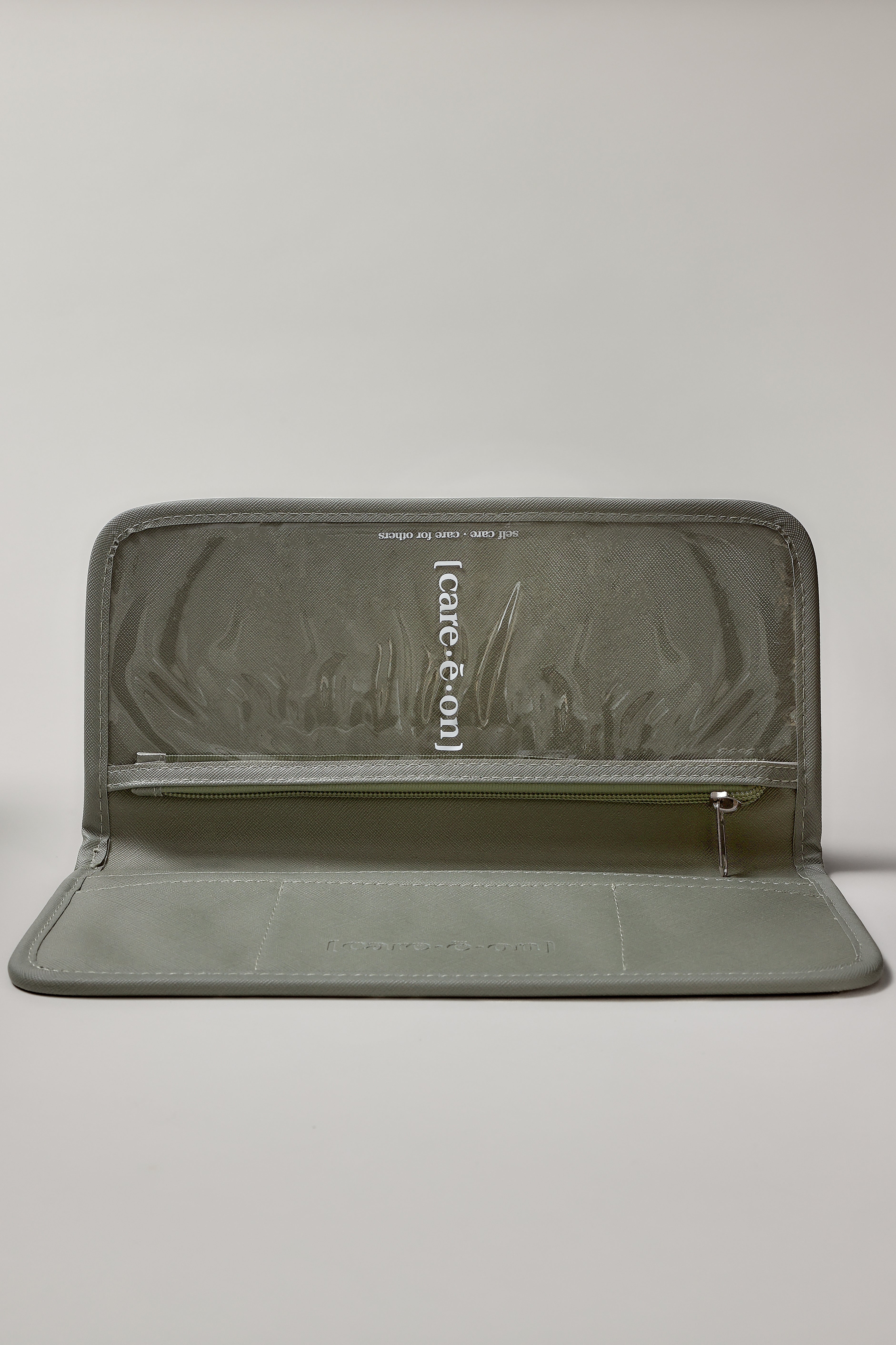 An olive green zippered pouch with a textured interior lining and a vertical white brand label reading 'careeon' on a light gray background.