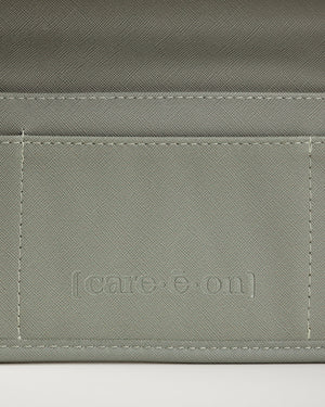 Close up detail view of the Care.ē.on Carry-All travel organizer in green.
