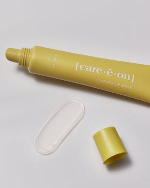 Care.ē.on Layover Lip Mask in its yellow tube with a swatch of the hydrating lip mask texture.