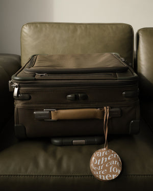 Care.ē.on Vegan Voyage Luggage Tag attached to a suitcase.