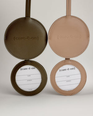 Care.ē.on Vegan Voyage Luggage Tags open to show the concealed traveler information cards.