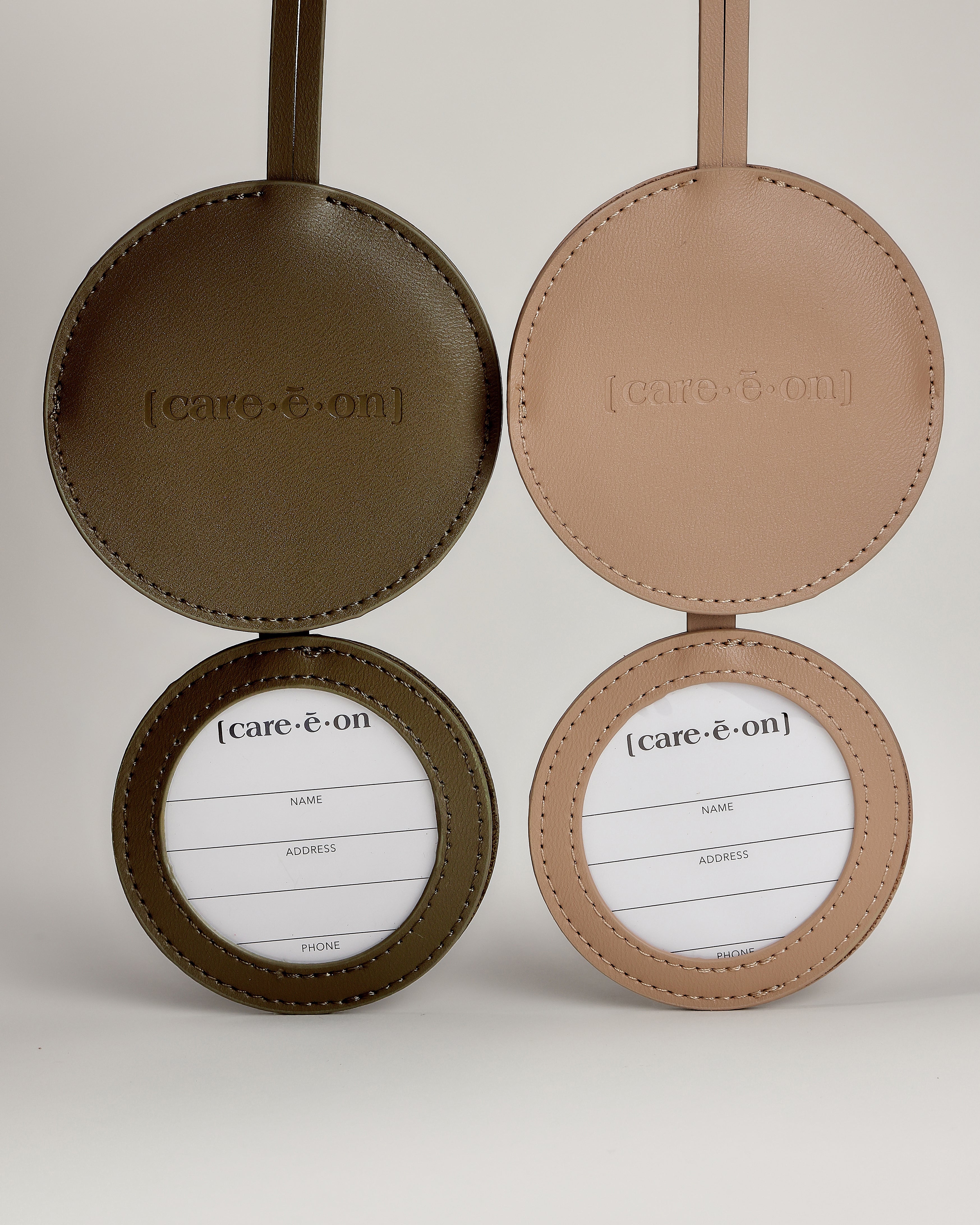 Care.ē.on Vegan Voyage Luggage Tags open to show the concealed traveler information cards.