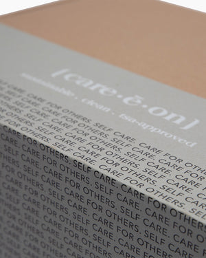 Close-up of the Care.ē.on PR/VIP Box with Care for Others, Self Care branding.